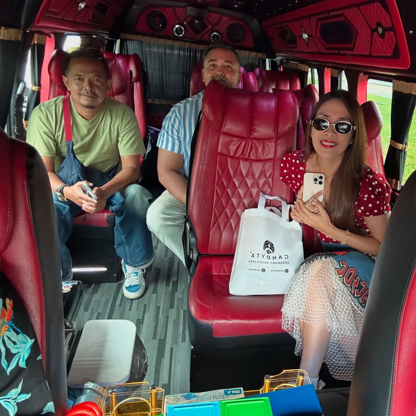 A family seated in a red lounge cabin